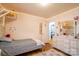 Bright bedroom featuring a twin bed, dresser, and access to another room at 7716 Elwood Dr, Charlotte, NC 28227