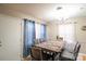 Dining area with wood table and blue curtains at 7716 Elwood Dr, Charlotte, NC 28227