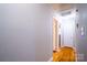 Bright hallway with hardwood floors and neutral walls at 7716 Elwood Dr, Charlotte, NC 28227