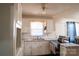 Classic kitchen with white cabinets and marble countertops at 7716 Elwood Dr, Charlotte, NC 28227