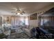 Living room with sectional sofa, coffee table, and ceiling fan at 7716 Elwood Dr, Charlotte, NC 28227