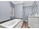 Bathroom with a jetted tub, double vanity, and tile flooring at 830 Lowder St, Albemarle, NC 28001