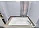 Bathroom featuring a jetted tub and tile surround at 830 Lowder St, Albemarle, NC 28001