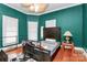 Spacious bedroom with dark green walls and hardwood floors at 830 Lowder St, Albemarle, NC 28001