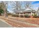 Quaint white house with a wrap-around porch and red brick accents at 830 Lowder St, Albemarle, NC 28001