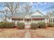 Charming white house with wrap-around porch and mature landscaping at 830 Lowder St, Albemarle, NC 28001