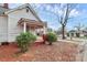 Side view of charming white house with wrap-around porch at 830 Lowder St, Albemarle, NC 28001