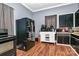 Kitchen with black refrigerator, stove, and white cabinets at 830 Lowder St, Albemarle, NC 28001