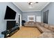 Large living room with L-shaped sofa and hardwood floors at 830 Lowder St, Albemarle, NC 28001