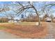 Vacant lot with mature trees and a gravel driveway at 830 Lowder St, Albemarle, NC 28001