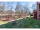 Landscaped backyard with playground at 8809 Landsdowne Ave, Harrisburg, NC 28075