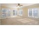 Bright bedroom with neutral carpet and multiple windows at 8809 Landsdowne Ave, Harrisburg, NC 28075