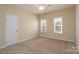 Well-lit bedroom featuring a closet and neutral decor at 8809 Landsdowne Ave, Harrisburg, NC 28075