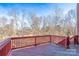 Wooden deck overlooking a wooded backyard at 8809 Landsdowne Ave, Harrisburg, NC 28075