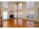 Bright living room with hardwood floors and a fireplace at 8809 Landsdowne Ave, Harrisburg, NC 28075