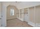 Spacious walk-in closet with built-in shelving at 8809 Landsdowne Ave, Harrisburg, NC 28075