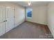 Well-lit bedroom with carpet and double door closet at 934 Pointe Andrews Dr, Concord, NC 28025