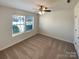 Well-lit bedroom with carpeted floor and window coverings at 934 Pointe Andrews Dr, Concord, NC 28025