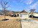 House exterior featuring a two-car garage and landscaped lawn at 934 Pointe Andrews Dr, Concord, NC 28025