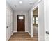 Welcoming foyer featuring a wooden front door and hardwood style flooring at 1007 Astoria Dr, Monroe, NC 28110