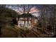 Spacious backyard featuring a screened porch, patio area, and mature trees at 1020 James Madison Dr, Weddington, NC 28104