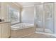 This bathroom has a tub, glass shower, and neutral colors at 1020 James Madison Dr, Weddington, NC 28104