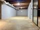 Spacious unfinished basement with exposed ductwork, concrete floor and sliding glass doors at 108 Vance Allen Ave, Rockwell, NC 28138