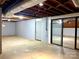 Unfinished basement with exposed pipes, concrete floors and sliding glass doors at 108 Vance Allen Ave, Rockwell, NC 28138