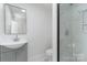 Modern bathroom with gray vanity, frameless shower, and marble tile at 108 Vance Allen Ave, Rockwell, NC 28138