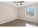 Cheerful bedroom with large window, wood-look floors, and ceiling fan at 108 Vance Allen Ave, Rockwell, NC 28138