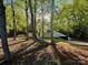 Secluded home with mature trees that offer shade and privacy; driveway and a partial view of the home at 108 Vance Allen Ave, Rockwell, NC 28138
