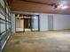 Spacious garage featuring a large roll-up door, painted brick walls and lots of room for vehicles and storage at 108 Vance Allen Ave, Rockwell, NC 28138