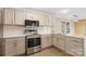 Updated kitchen with stainless steel appliances and white cabinets at 108 Vance Allen Ave, Rockwell, NC 28138