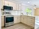 The updated kitchen features stainless steel appliances, modern countertops, and ample cabinet space for storage at 108 Vance Allen Ave, Rockwell, NC 28138
