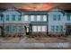 Two story townhome with stone and siding exterior at dusk at 1412 Galloway Rd, Charlotte, NC 28262