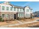 Townhome features stone and siding exterior, and landscaping at 1412 Galloway Rd, Charlotte, NC 28262