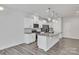 Modern kitchen with island, white cabinets, and granite counters at 1412 Galloway Rd, Charlotte, NC 28262
