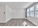 Bright living room with large windows and wood-look flooring at 1412 Galloway Rd, Charlotte, NC 28262