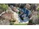Expansive aerial view of home with a pool, lush greenery, circular drive and three-car garage at 14407 Brick Church Ct, Charlotte, NC 28277