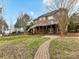 Large backyard featuring multi-story brick home, patio and stairs at 14407 Brick Church Ct, Charlotte, NC 28277