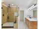 Bright bathroom with wood-look shower, marble countertop, and tile floors at 14407 Brick Church Ct, Charlotte, NC 28277