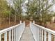 Picturesque bridge leading to a wooded area, enhancing the property's charm at 14407 Brick Church Ct, Charlotte, NC 28277