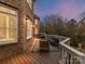 Spacious wooden deck featuring stylish outdoor furniture and a peaceful view at 14407 Brick Church Ct, Charlotte, NC 28277