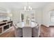 Bright dining room features an elegant chandelier, bay window, and beautiful hardwood floors at 14407 Brick Church Ct, Charlotte, NC 28277