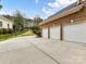 Spacious three car garage with brick exterior and concrete driveway at 14407 Brick Church Ct, Charlotte, NC 28277