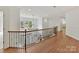 Spacious hallway with hardwood floors and a decorative wrought iron railing at 14407 Brick Church Ct, Charlotte, NC 28277