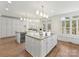 Large kitchen featuring granite counters, double islands, and lots of natural light at 14407 Brick Church Ct, Charlotte, NC 28277