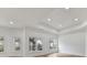 Well lit living room with three windows, wood floors and recessed lighting at 14407 Brick Church Ct, Charlotte, NC 28277