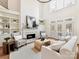 Bright living room with high ceilings, fireplace, built-in shelving, and stylish contemporary furnishings at 14407 Brick Church Ct, Charlotte, NC 28277