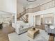 Spacious open living area featuring staircase, hardwood floors, and elegant decor at 14407 Brick Church Ct, Charlotte, NC 28277